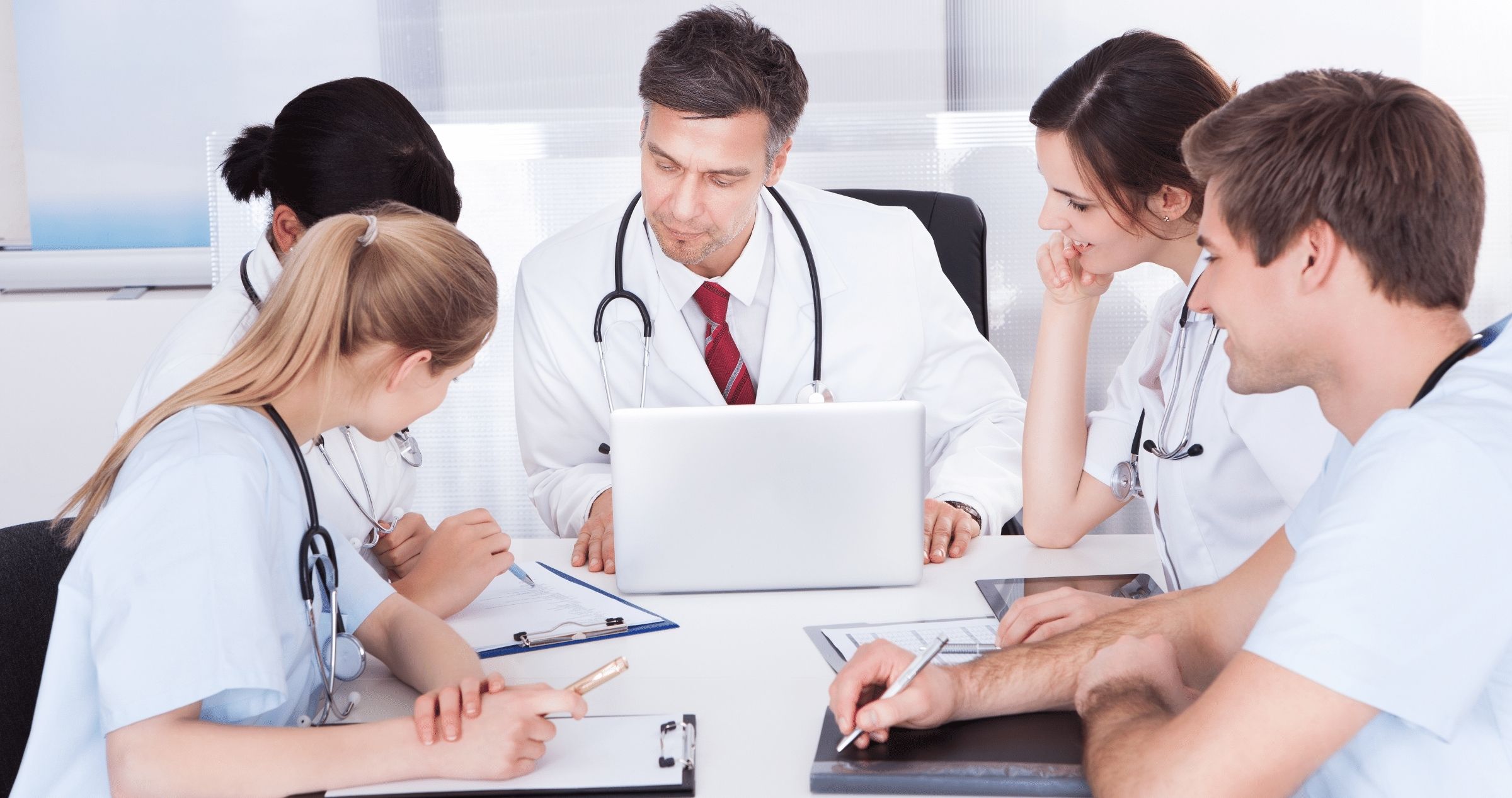 Group of health care students sitting at desk having meeting